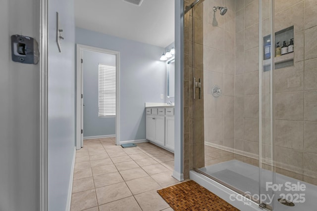 bathroom with vanity, an enclosed shower, and tile patterned flooring