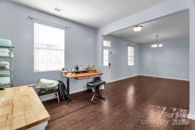 interior space featuring dark hardwood / wood-style flooring and a notable chandelier