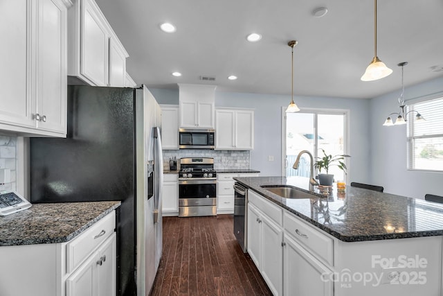 kitchen featuring appliances with stainless steel finishes, sink, and white cabinets