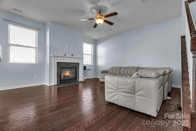 living room with dark wood-type flooring and ceiling fan