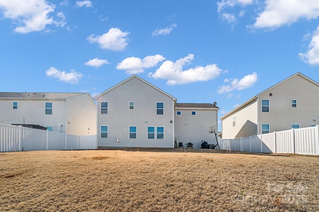 rear view of house featuring a yard