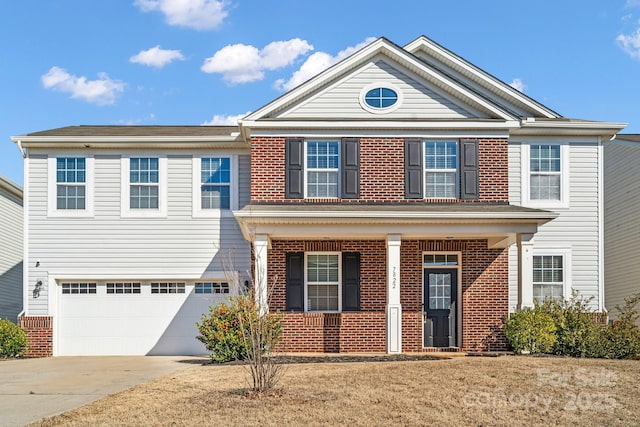 view of front of home featuring a garage, a front yard, and covered porch