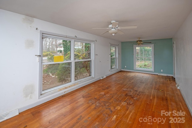 unfurnished room with hardwood / wood-style flooring and ceiling fan