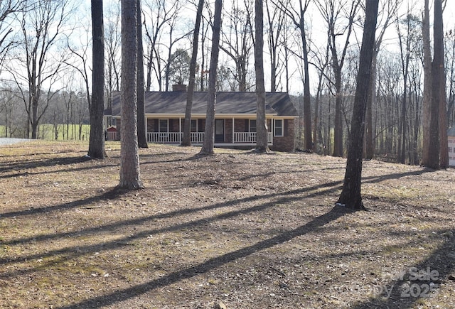 ranch-style house with a porch and brick siding