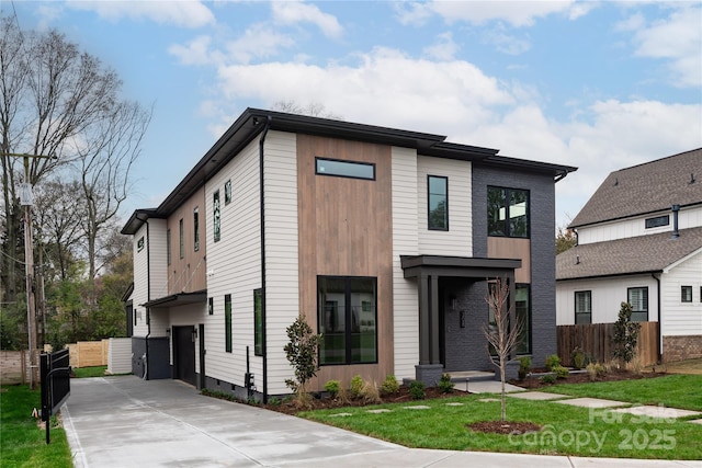 modern home featuring a front lawn