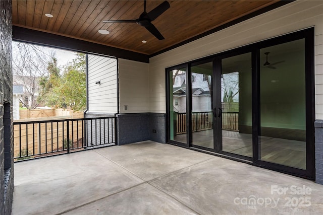 unfurnished sunroom with wooden ceiling and ceiling fan