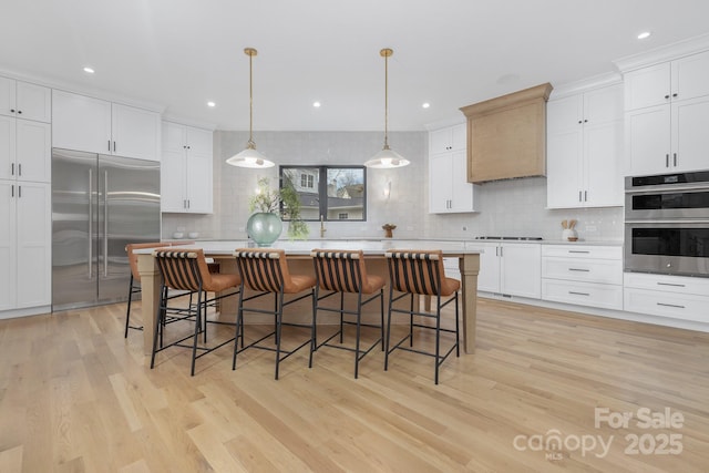 kitchen featuring tasteful backsplash, appliances with stainless steel finishes, a center island, and white cabinets