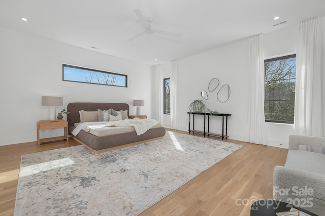 bedroom with ceiling fan and light wood-type flooring