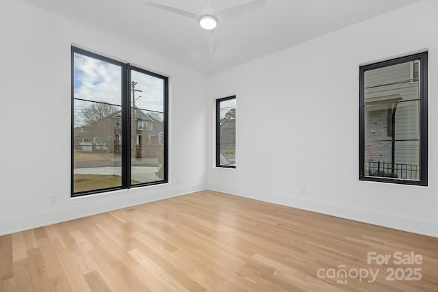 unfurnished room with ceiling fan and light wood-type flooring