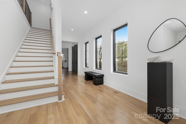 stairs with hardwood / wood-style flooring