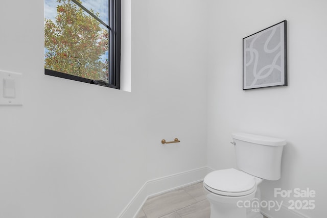 bathroom with tile patterned flooring and toilet