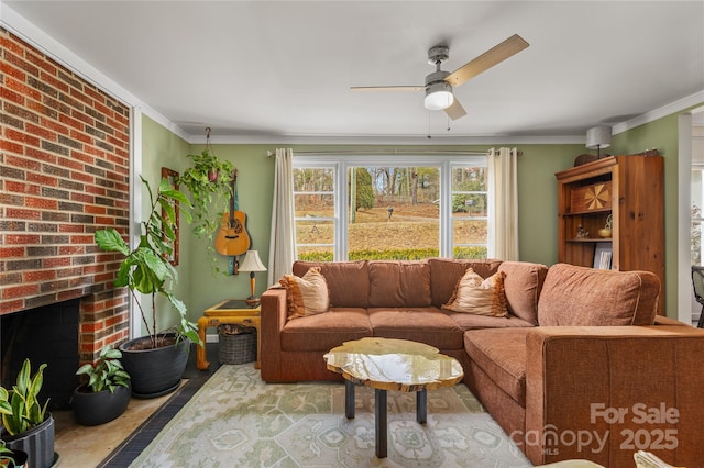 living room featuring crown molding, ceiling fan, and a fireplace