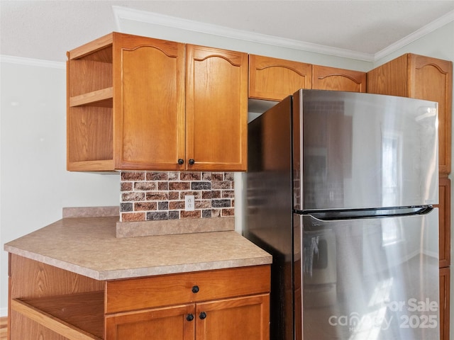 kitchen featuring tasteful backsplash, stainless steel fridge, and ornamental molding