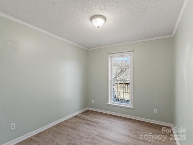 spare room featuring crown molding, light hardwood / wood-style flooring, and a textured ceiling