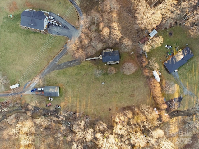 birds eye view of property with a rural view