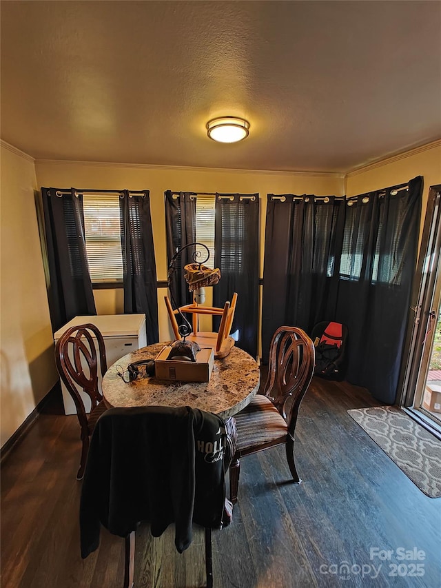 dining room with dark wood-type flooring and a textured ceiling