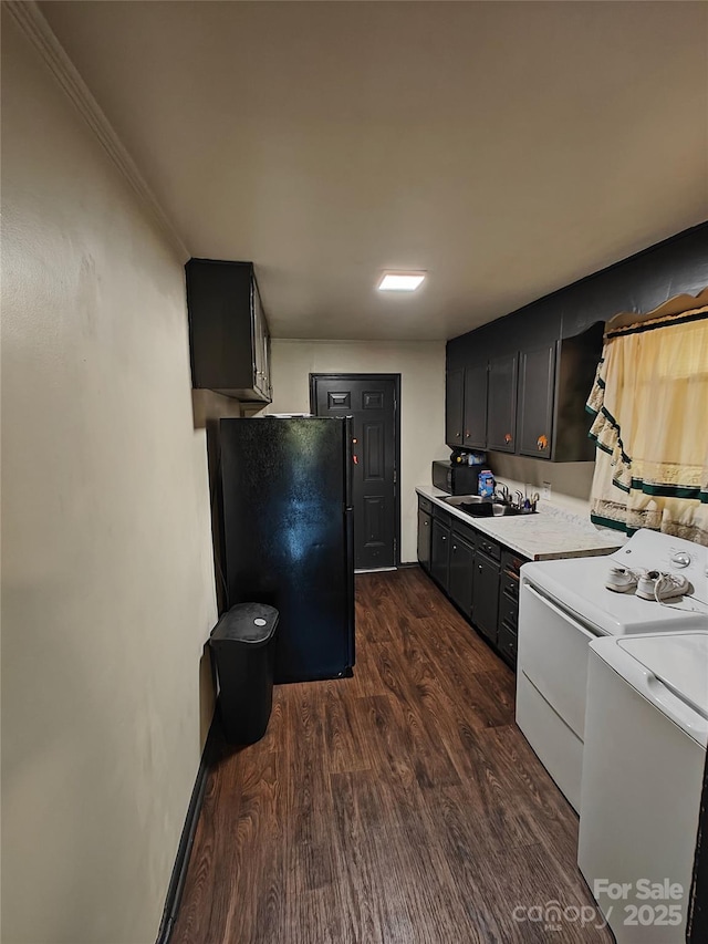 3103 Minnesota Rd, Charlotte, NC 28208 - kitchen with washing machine and clothes dryer, sink, crown molding, dark hardwood / wood-style floors, and black appliances