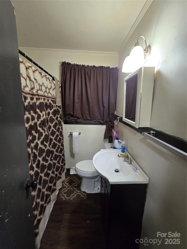 3103 Minnesota Rd, Charlotte, NC 28208 - bathroom featuring ornamental molding, vanity, toilet, and hardwood / wood-style floors