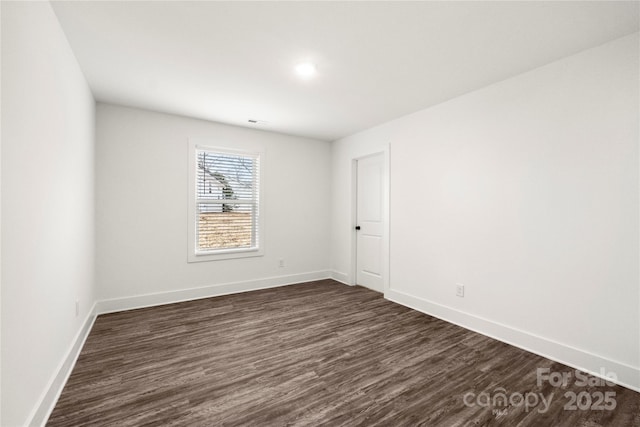 unfurnished room featuring dark hardwood / wood-style flooring