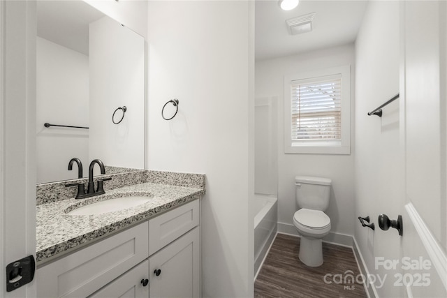 bathroom featuring hardwood / wood-style flooring, vanity, and toilet