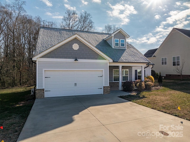 view of front of property with a garage and a front lawn