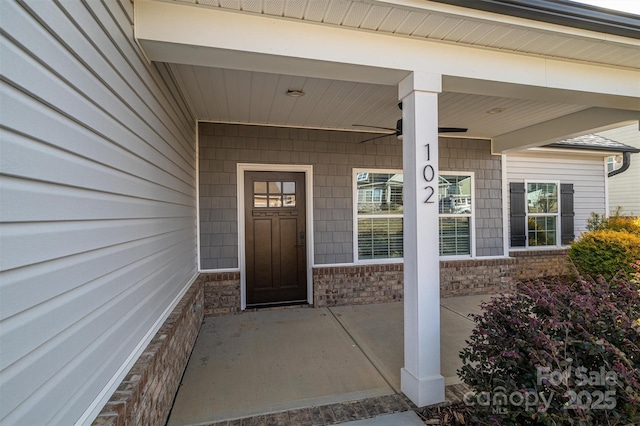 doorway to property with ceiling fan and covered porch