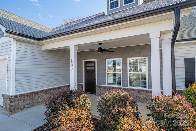 view of exterior entry featuring ceiling fan and covered porch