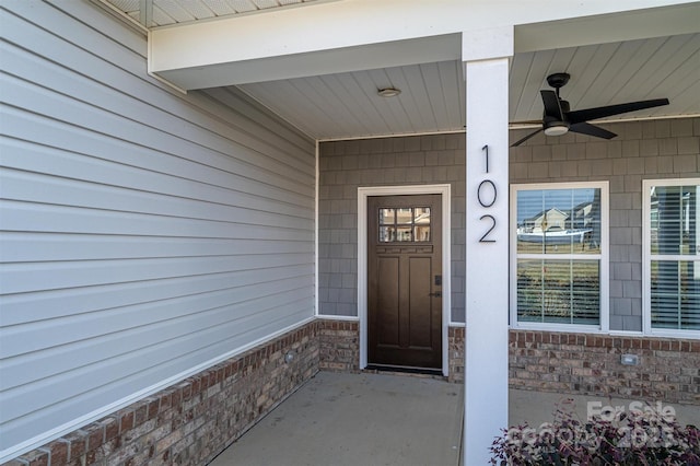 doorway to property featuring ceiling fan