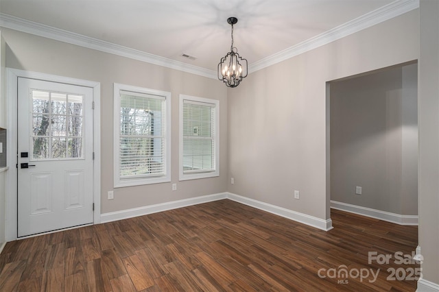 unfurnished room featuring crown molding, dark hardwood / wood-style floors, and an inviting chandelier