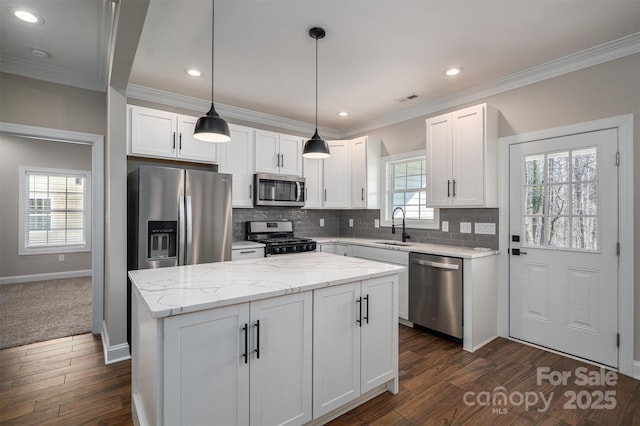 kitchen featuring a kitchen island, white cabinetry, and appliances with stainless steel finishes