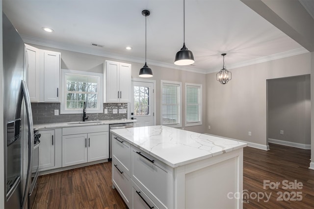 kitchen featuring white cabinetry, sink, hanging light fixtures, a center island, and stainless steel appliances