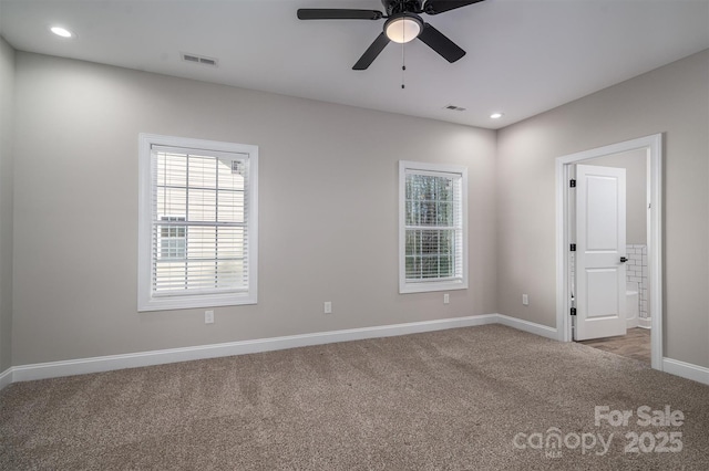 spare room featuring carpet and ceiling fan