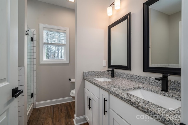 bathroom featuring vanity, an enclosed shower, and toilet