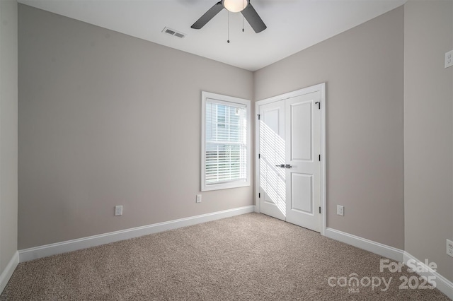 unfurnished bedroom with ceiling fan and carpet flooring