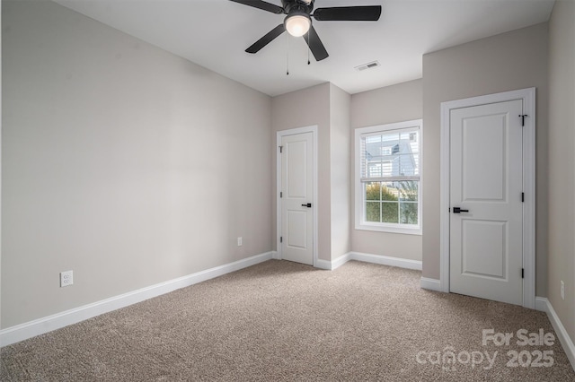 unfurnished bedroom with light colored carpet and ceiling fan