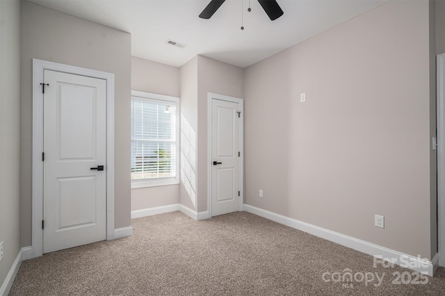 unfurnished bedroom featuring ceiling fan and carpet flooring