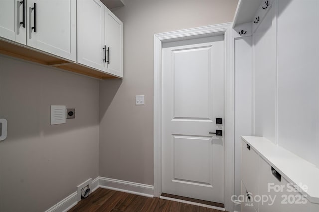 laundry room featuring cabinets, dark wood-type flooring, and hookup for an electric dryer