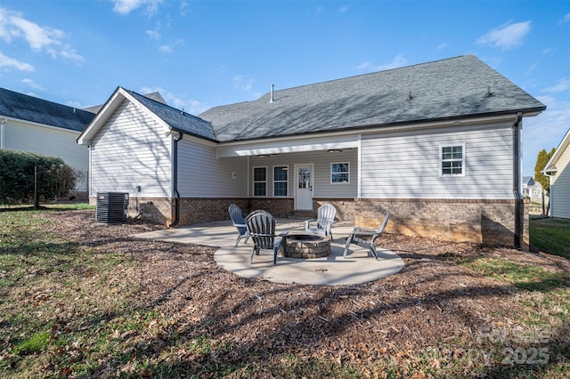 back of property featuring a fire pit, a patio area, and central AC