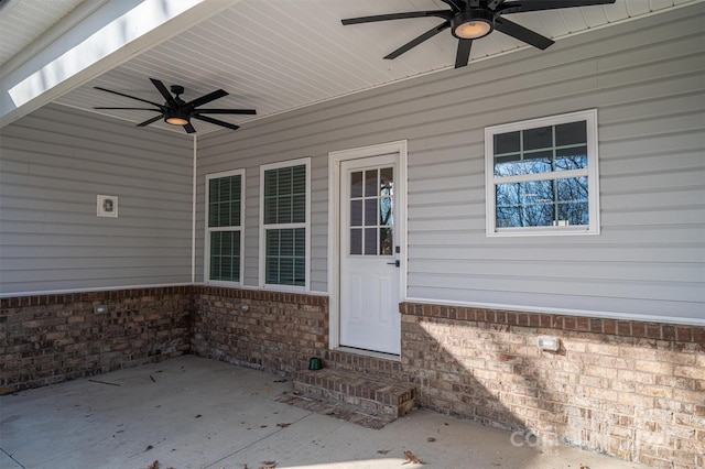 property entrance featuring ceiling fan and a patio area