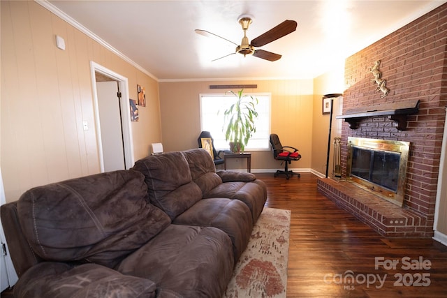 living room with ceiling fan, a fireplace, ornamental molding, and dark hardwood / wood-style flooring