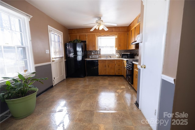 kitchen with sink, ceiling fan, range hood, tasteful backsplash, and black appliances