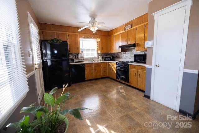 kitchen featuring backsplash, black appliances, sink, and ceiling fan