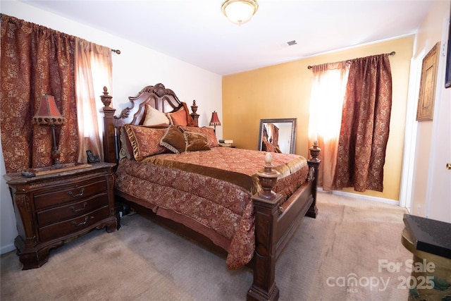 bedroom featuring light colored carpet