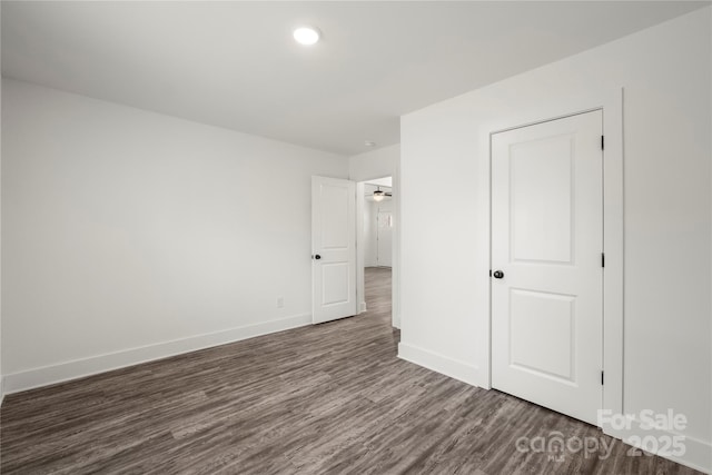 empty room with dark wood-type flooring