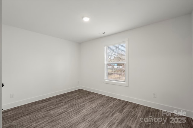 empty room featuring dark wood-type flooring