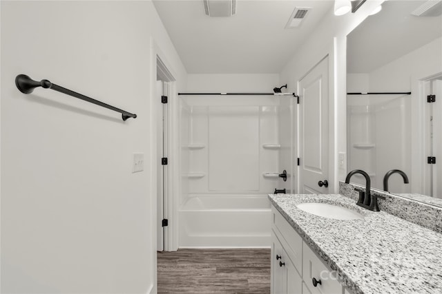 bathroom with vanity, hardwood / wood-style floors, and bathtub / shower combination