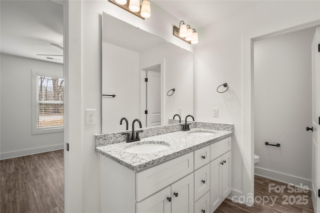 bathroom with vanity, hardwood / wood-style floors, and toilet