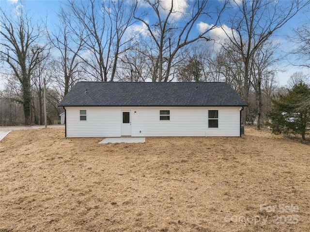 rear view of house with a yard and a patio