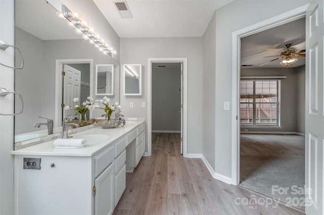 bathroom featuring hardwood / wood-style flooring, vanity, and ceiling fan