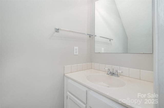 bathroom with vanity and vaulted ceiling